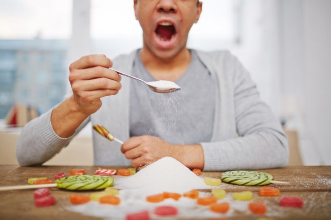 Man eating sugar